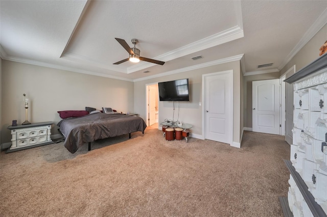 bedroom featuring crown molding, carpet flooring, ceiling fan, a textured ceiling, and a tray ceiling