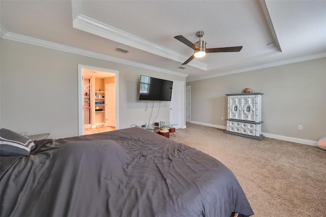 unfurnished bedroom with ceiling fan, a raised ceiling, carpet floors, and ornamental molding