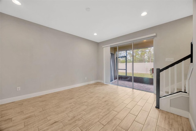 empty room with light hardwood / wood-style flooring