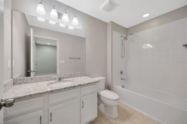 full bathroom with tile patterned flooring, vanity, tiled shower / bath combo, and toilet