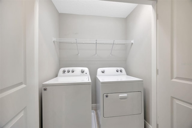 clothes washing area featuring separate washer and dryer