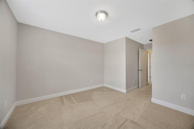 empty room with light colored carpet