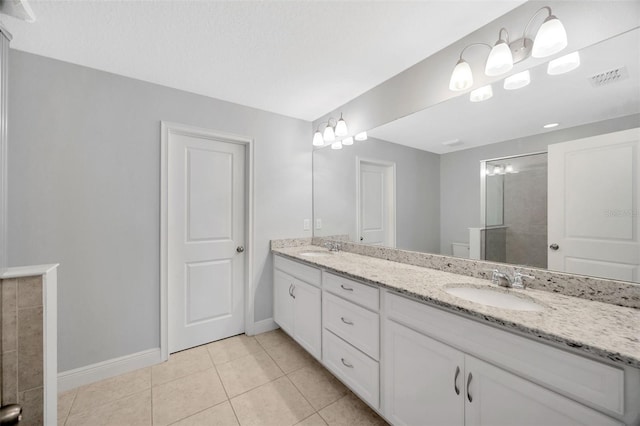 bathroom featuring vanity, tile patterned flooring, and a shower with door