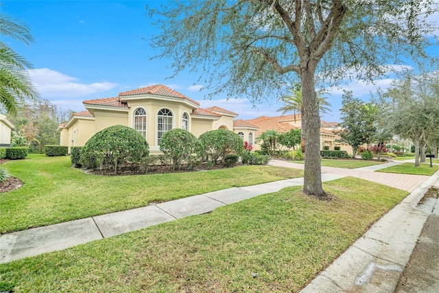 mediterranean / spanish home featuring a front yard