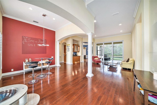 living room featuring ornamental molding and dark hardwood / wood-style flooring