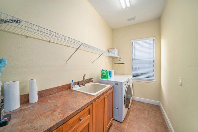 laundry room featuring sink, separate washer and dryer, cabinets, and light tile patterned floors