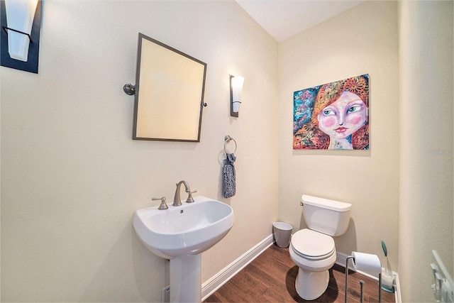 bathroom with hardwood / wood-style flooring and toilet