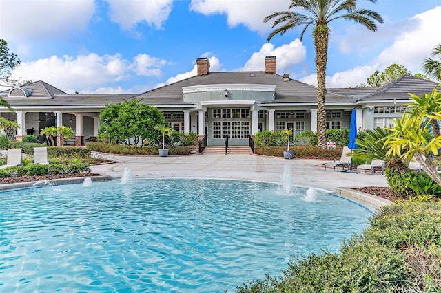 view of pool featuring french doors