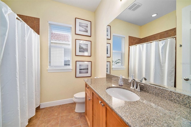 bathroom featuring toilet, vanity, and tile patterned flooring