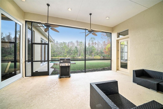 sunroom with ceiling fan and a healthy amount of sunlight