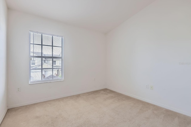 unfurnished room with light carpet