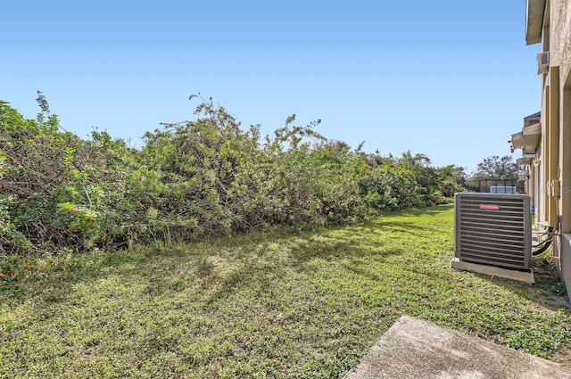 view of yard featuring central air condition unit