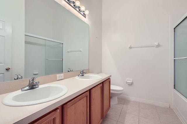 full bathroom featuring tile patterned flooring, vanity, toilet, and shower / bath combination with glass door