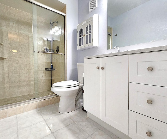 bathroom featuring vanity, toilet, and an enclosed shower