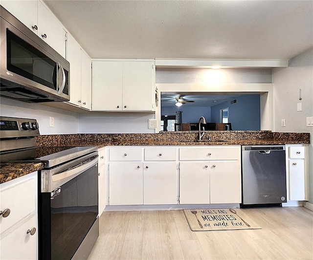 kitchen with white cabinetry, appliances with stainless steel finishes, sink, and light hardwood / wood-style flooring