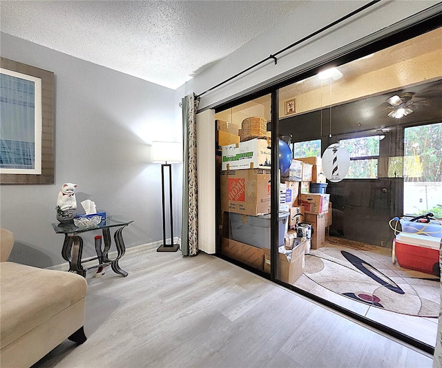 interior space with a textured ceiling and light wood-type flooring