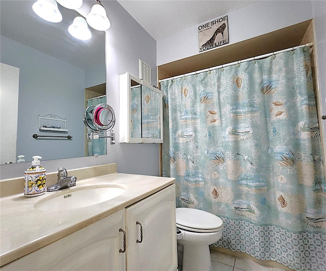 bathroom featuring tile patterned floors, toilet, and vanity