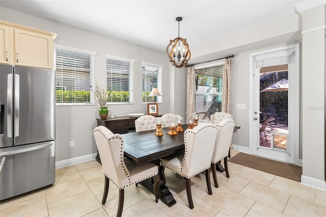 dining space with light tile patterned flooring and a chandelier