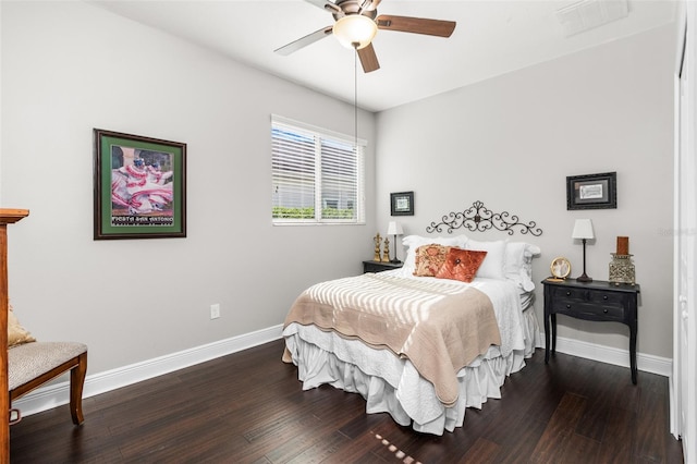 bedroom with dark hardwood / wood-style flooring and ceiling fan