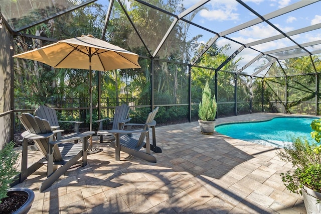 view of pool featuring a patio area and glass enclosure