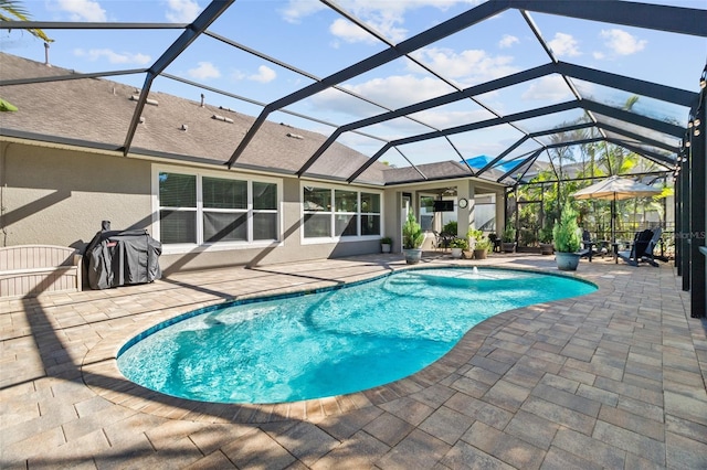 view of pool featuring area for grilling, a patio, and glass enclosure