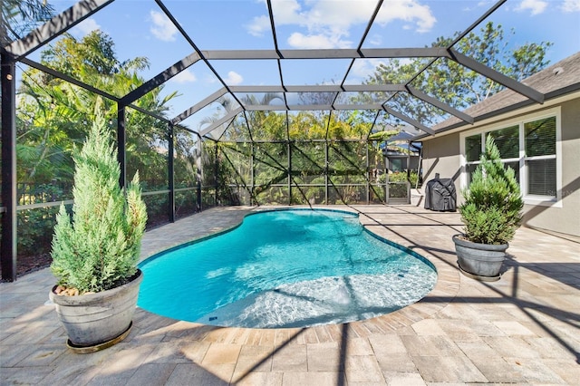 view of swimming pool with a patio area and glass enclosure