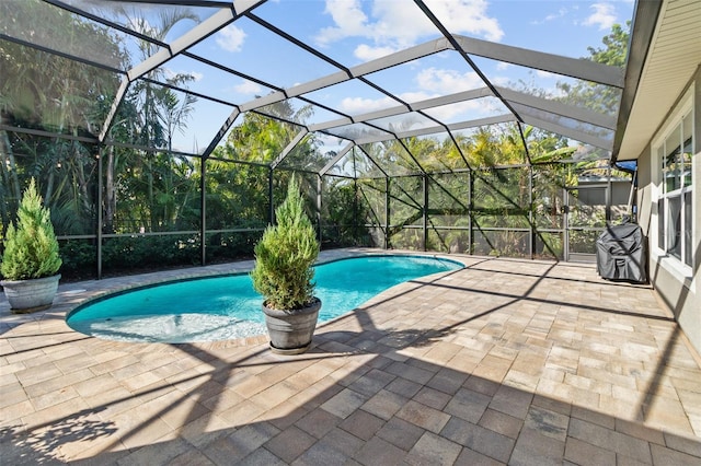 view of swimming pool featuring a lanai and a patio area