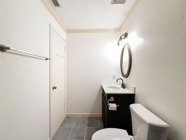 bathroom with toilet, vanity, crown molding, and tile patterned flooring