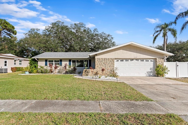 ranch-style house featuring a front yard and a garage