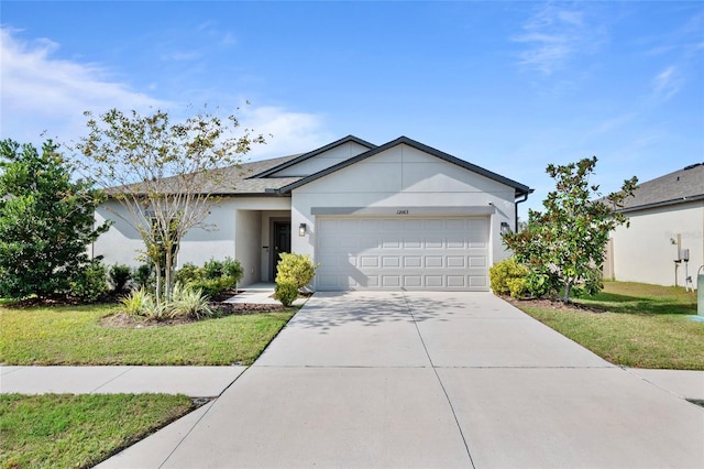 view of front of property featuring a front lawn and a garage