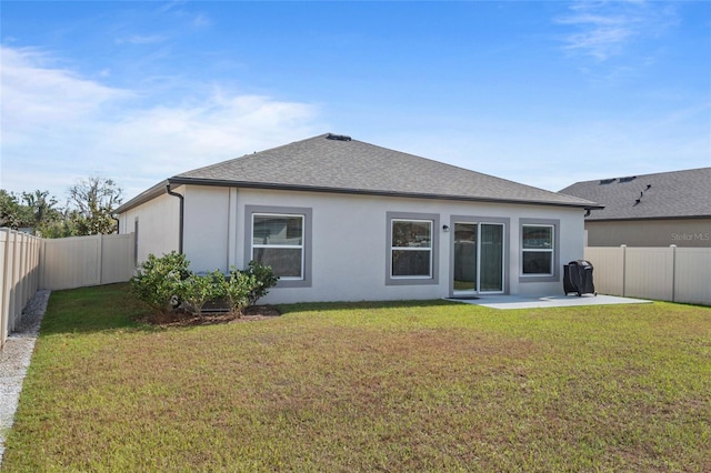 back of house with a patio and a lawn