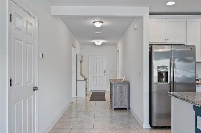 hallway featuring light tile patterned floors