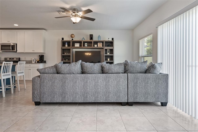 living room featuring ceiling fan and light tile patterned floors