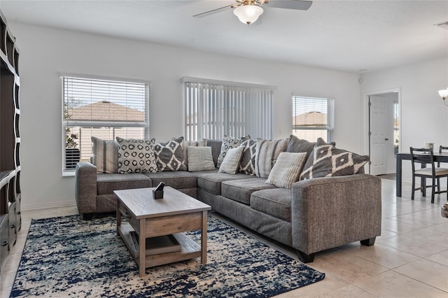 living room featuring light tile patterned floors, plenty of natural light, and ceiling fan