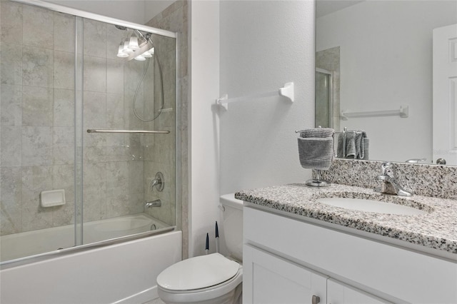 full bathroom featuring vanity, enclosed tub / shower combo, and toilet