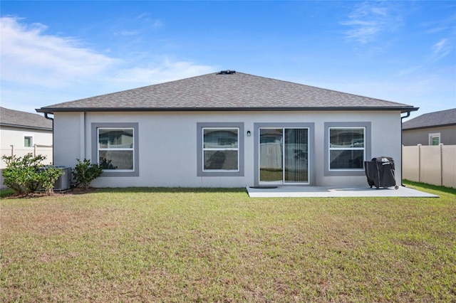 rear view of house with a yard, cooling unit, and a patio area