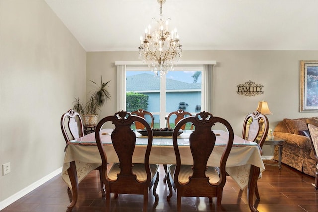 dining room with dark hardwood / wood-style flooring and an inviting chandelier