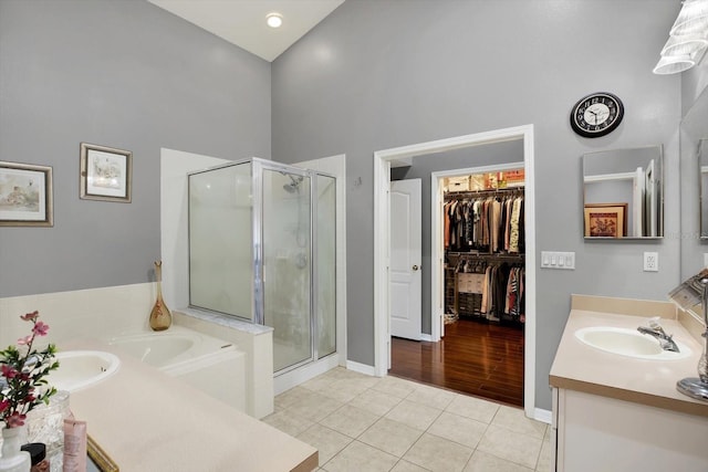 bathroom featuring tile patterned flooring, vanity, and independent shower and bath