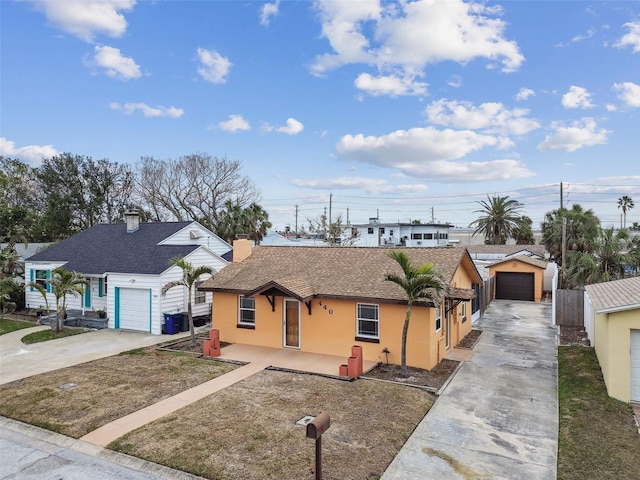 440 77th Ave, St Pete Beach, FL 33706 - view of front of property with driveway, stucco siding, a garage, roof with shingles, and a chimney