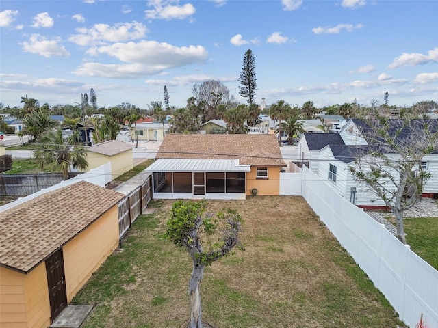 440 77th Ave, St Pete Beach, FL 33706 - back of house with a sunroom, a fenced backyard, and a residential view
