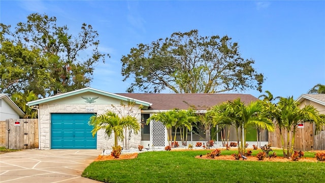 ranch-style home with a front lawn and a garage