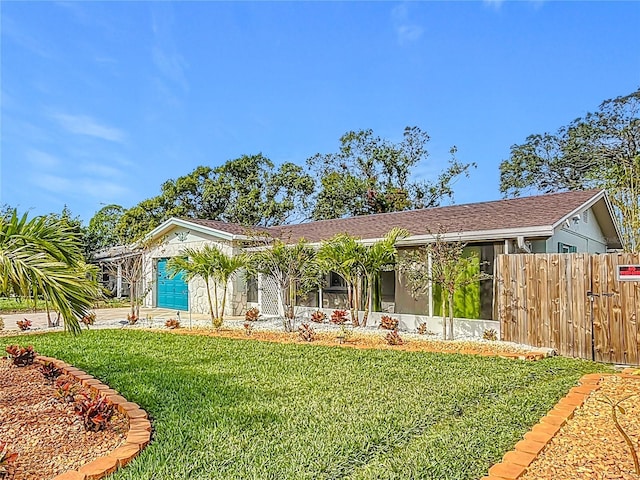 view of front facade featuring a front yard and a garage