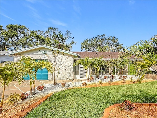 view of front of home featuring a garage and a front lawn