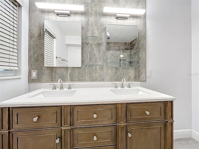 bathroom featuring vanity and a shower with door