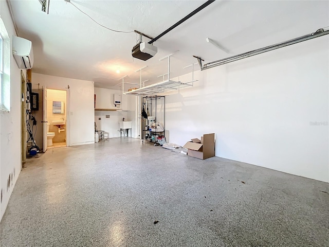 garage with a wall mounted AC, sink, and a garage door opener