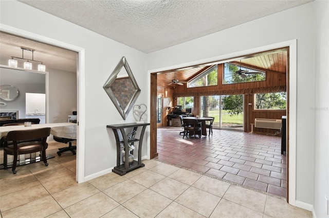 interior space with light tile patterned floors, a textured ceiling, lofted ceiling, and wood ceiling