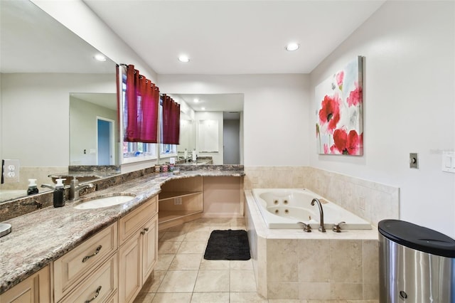 bathroom with vanity, tile patterned floors, and tiled tub