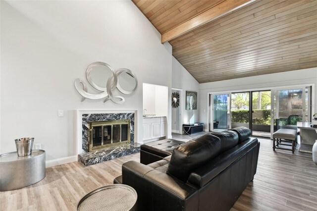 5474 Kemkerry Rd, Wesley Chapel, FL 33543 - living room with wood ceiling with exposed beams, high vaulted ceiling, baseboards, wood finished floors, and a fireplace