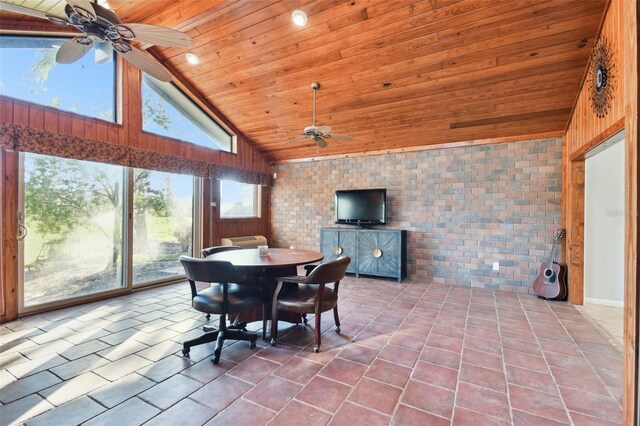5474 Kemkerry Rd, Wesley Chapel, FL 33543 - dining space featuring ceiling fan, wood ceiling, high vaulted ceiling, tile patterned flooring, and brick wall