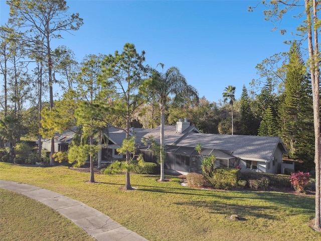 5474 Kemkerry Rd, Wesley Chapel, FL 33543 - view of front facade featuring a front lawn and a chimney